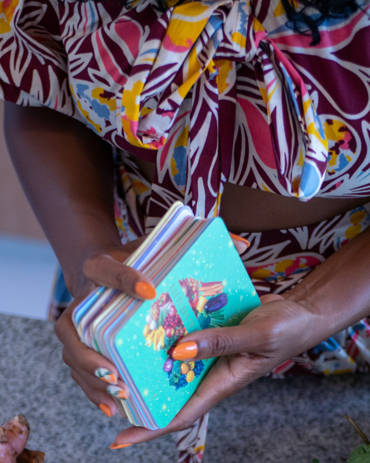 Person holding the Nourish & Thrive Juicing Oracle Deck.
